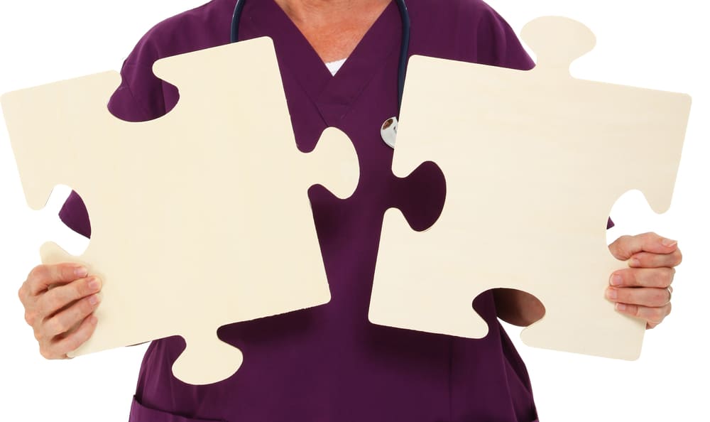 nurse in a home care for autistic adults holding puzzle pieces representing autism.