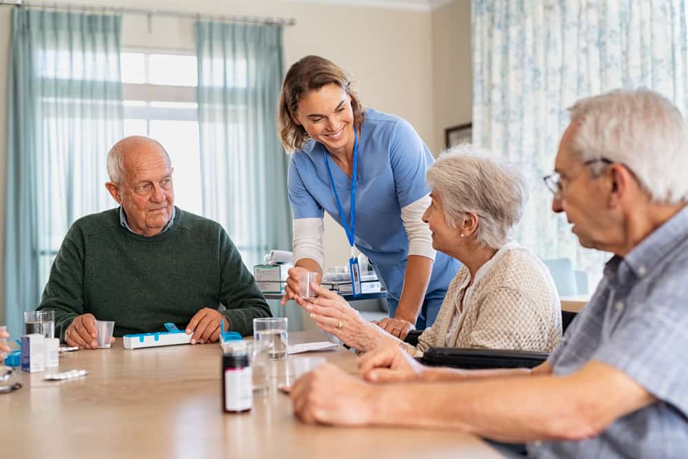 live in caregiver in happy conversation with family members of her patient
