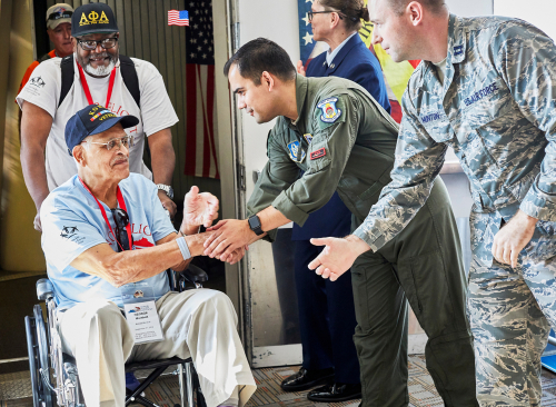 young army officers greeting elderly veterans on VA day celebrations