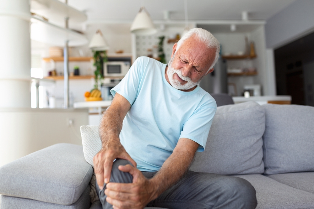 an old man suffering from osteoarthritis